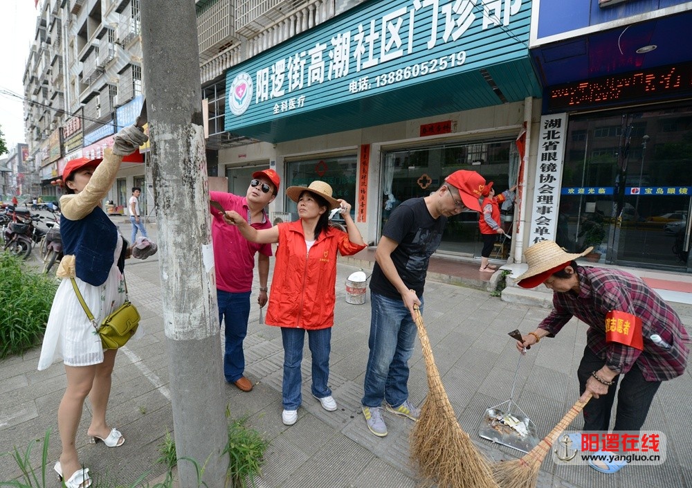 新洲区房管局志愿者和朝家山社区工作人员一起清理牛皮癣广告.jpg